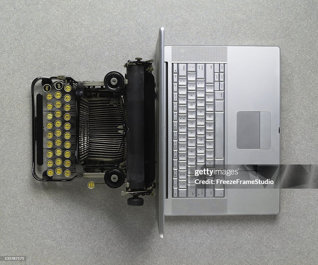 Classic analog typewriter vs Modern digital hi-tech laptop computer