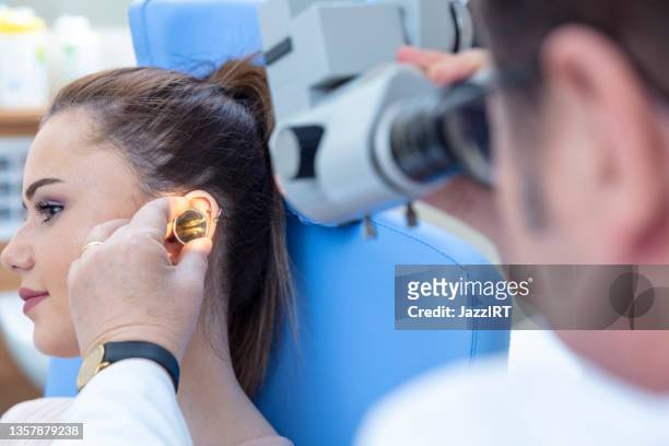 ear check-up - otoscope stock pictures, royalty-free photos & images