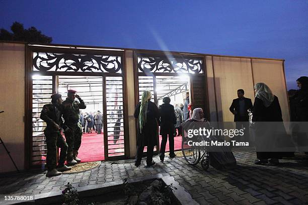 Iraqi Army special forces soldiers keep watch at a women's art exhibition sponsored by Iraqi Parliament member Safi Asiheil in a posh Baghdad...