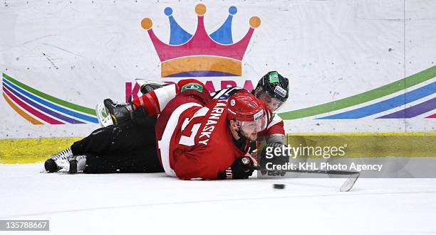 Nick Tarnasky of the Vityaz reaches for the puck after falling with referee Vyacheslav Bulanov during the game between Salavat Yulaev Ufa and Vityaz...