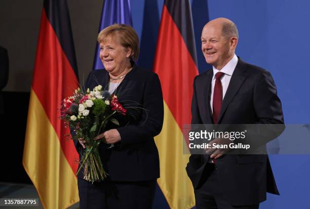 New German Chancellor Olaf Scholz and former German Chancellor Angela Merkel pose for a photo during the official transfer of office at the...