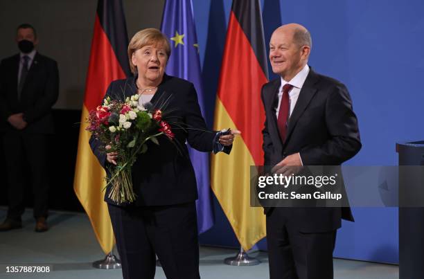 New German Chancellor Olaf Scholz and former German Chancellor Angela Merkel pose for a photo during the official transfer of office at the...