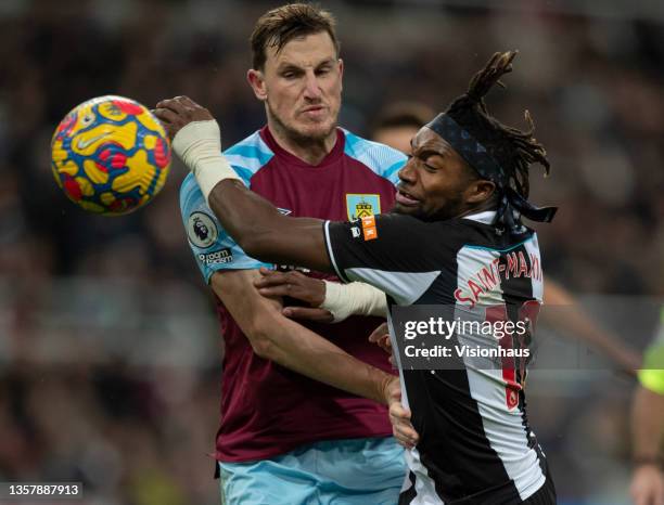 Allan Saint-Maximin of Newcastle United and Chris Wood of Burnley in action during the Premier League match between Newcastle United and Burnley at...
