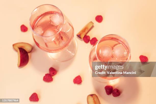 two refreshing glasses of rosé with fruit - rose wine stock pictures, royalty-free photos & images