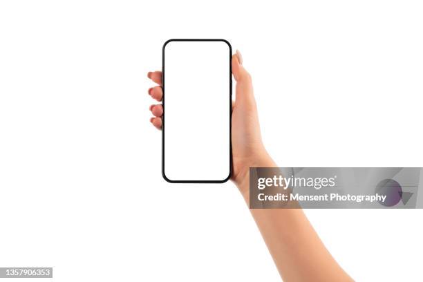 woman hand holding smartphone mockup with white screen on white background - holding mobile phone stock-fotos und bilder