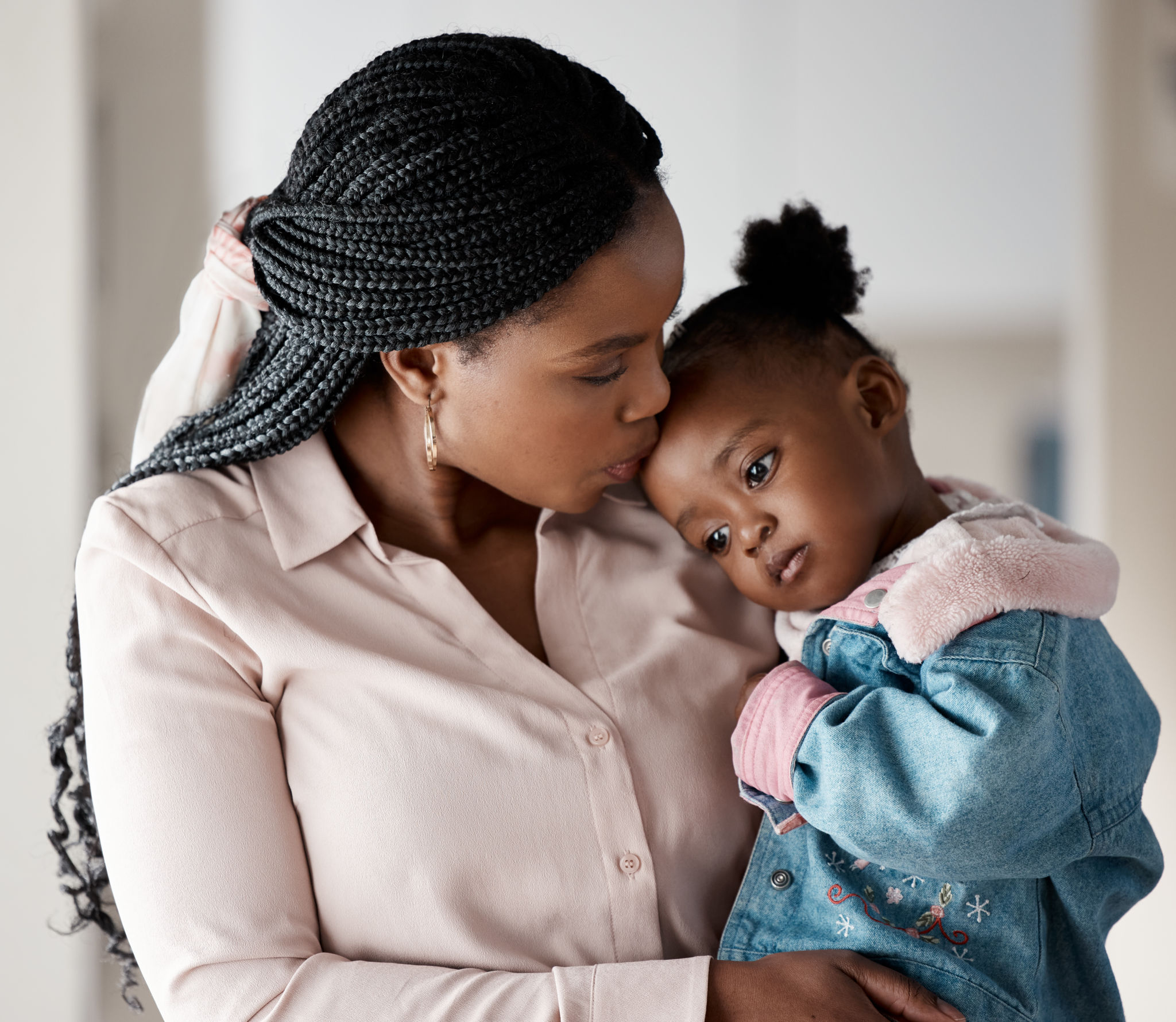 Shot of a woman holding her daughter while at home Shot of a woman holding her daughter while at home