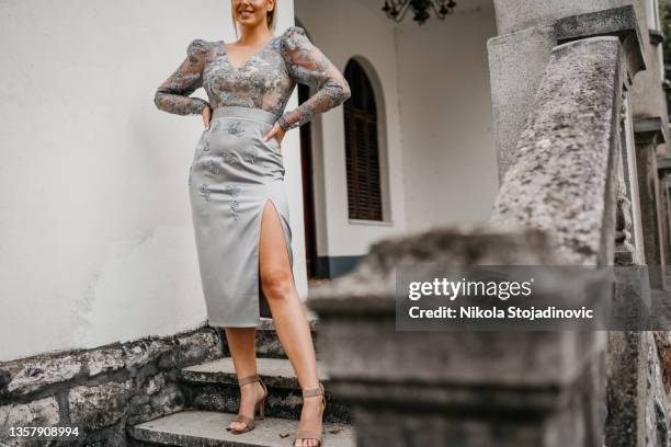 woman in dress front of the staircase - grey dress stock pictures, royalty-free photos & images