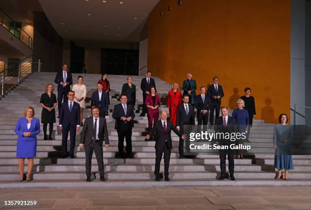 Members of the new German government cabinet, including new Chancellor Olaf Scholz , pose for a photo after convening for the first time at the...