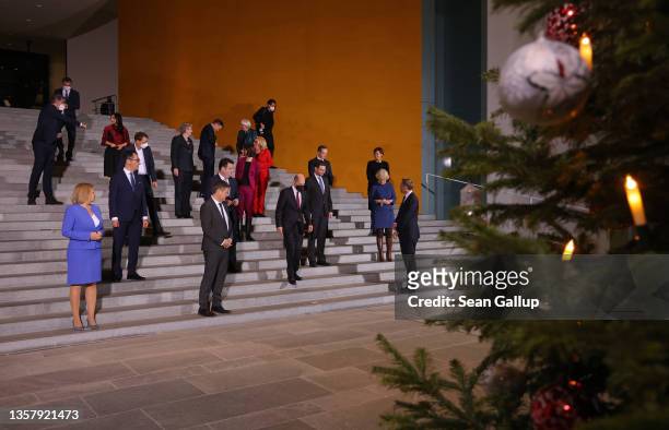Members of the new German government cabinet, including new Chancellor Olaf Scholz , arrive for a group photo after convening for the first time at...