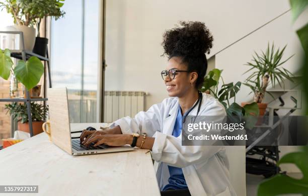 doctor using laptop at home office - doctor using laptop stock pictures, royalty-free photos & images