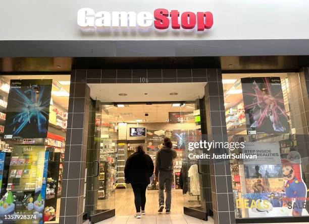 Customers enter a GameStop store on December 08, 2021 in San Rafael, California. Video game retailer GameStop will report third quarter earnings...