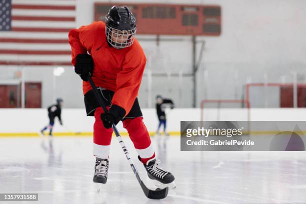 boy training ice hockey - ice hockey stockfoto's en -beelden