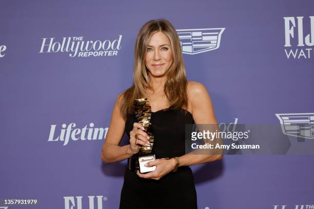Jennifer Aniston poses with the Sherry Lansing Leadership Award at The Hollywood Reporter 2021 Power 100 Women in Entertainment, presented by...