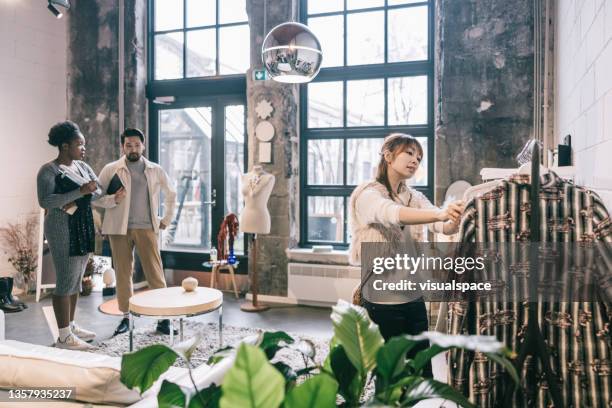 asisan woman looking at clothes in store - fashionable shopping stock pictures, royalty-free photos & images