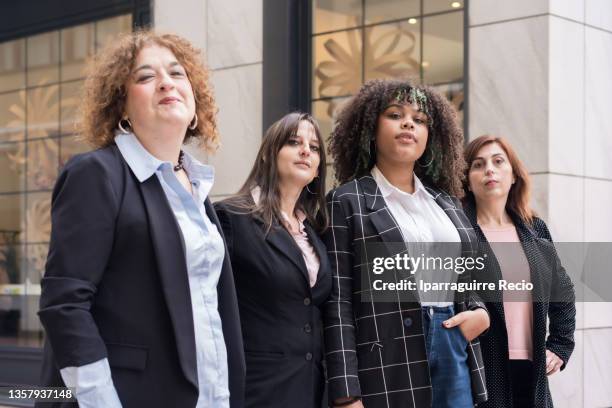 businesswomen outside the office, portrait of women workers of different ethnicities and multigenerational - basque cooperative imagens e fotografias de stock