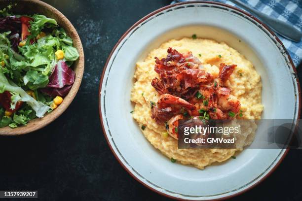 creamy grits with fried shrimps and bacon - shrimp and grits stock pictures, royalty-free photos & images