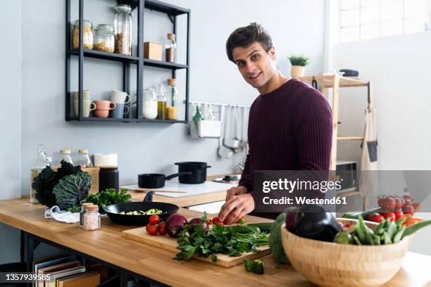 Man Cutting Vegetables In Kitchen Photos and Premium High Res Pictures ...