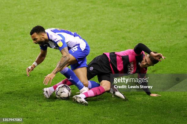 Curtis Tilt of Wigan Athletic is challenged by Joshua Daniels of Shrewsbury Town during the Sky Bet League One match between Wigan Athletic and...