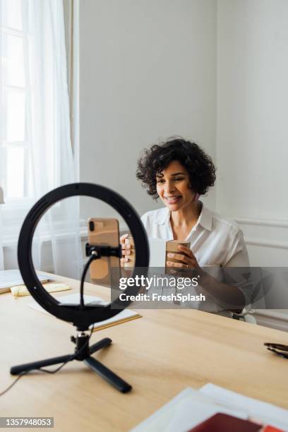 a hard-working african-american woman advertising some product in a live video - american influencer stock pictures, royalty-free photos & images