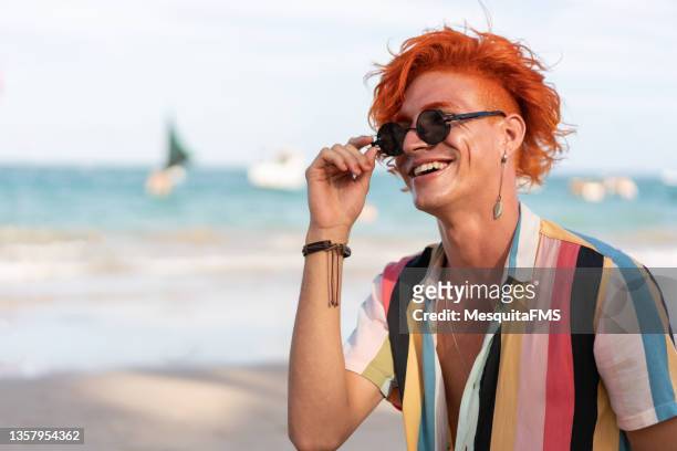 portrait of young redhead on the beach - gay man bildbanksfoton och bilder