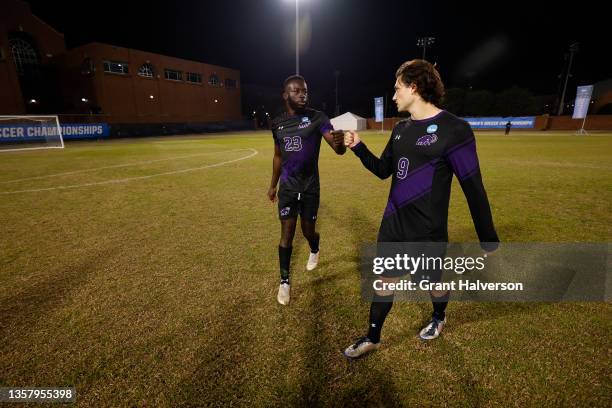 Ada Okorogheye of Amherst Mammoths and German Giammattei of Amherst Mammoths fist bump before the game against the Connecticut Camels during the...