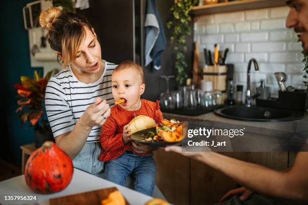 mom i want more! - young family in kitchen stock pictures, royalty-free photos & images