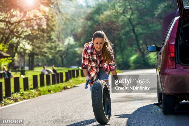 woman has a car problem on the road stock photo - the fall band stockfoto's en -beelden