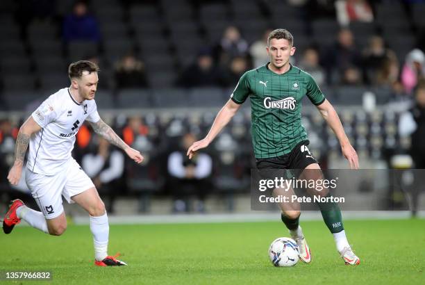 Jordan Houghton of Plymouth Argyle controls the ball watched by Josh McEachran of Milton Keynes Dons during the Sky Bet League One match between...