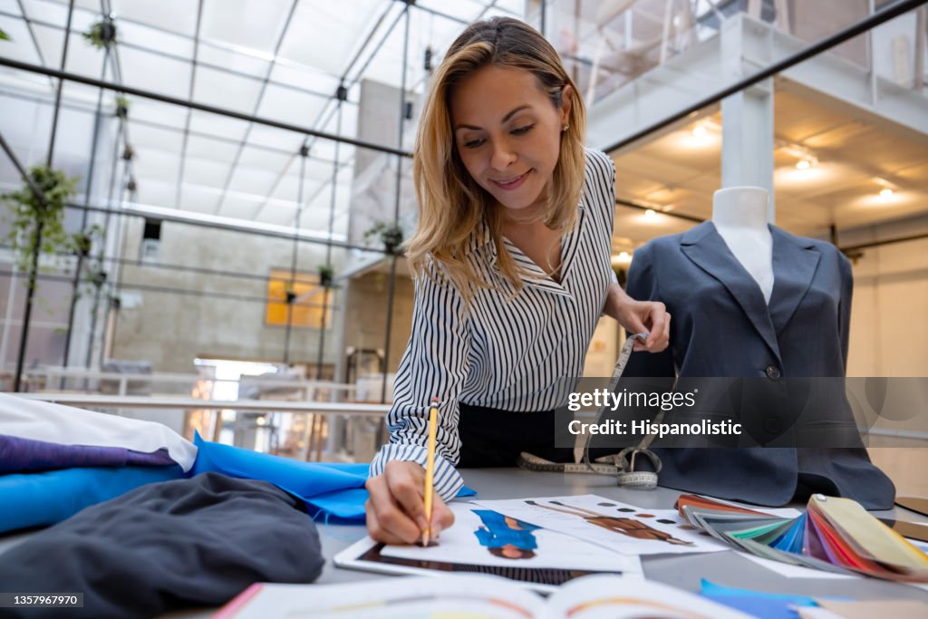 Fashion designer sketching a design at her atelier
