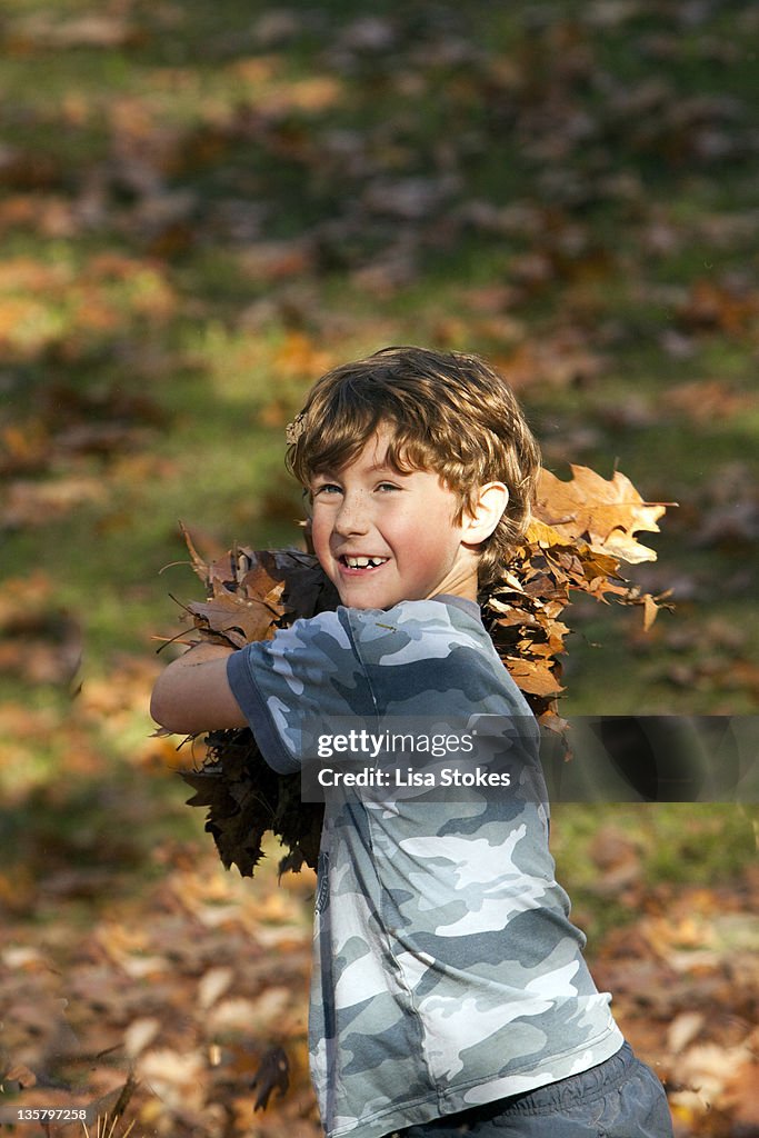 Boy throwing Leaves