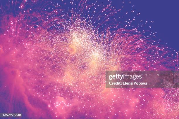 purple and pink fireworks display against dark night sky - petard stock pictures, royalty-free photos & images