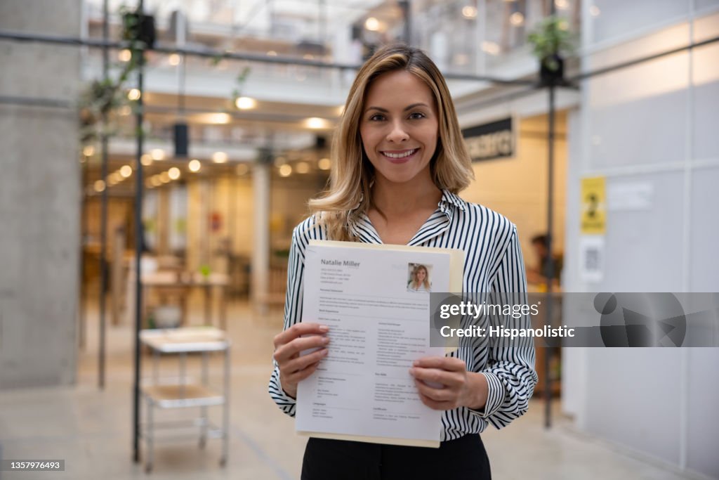 Happy business woman holding her CV for a job interview