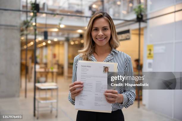 happy business woman holding her cv for a job interview - cv bildbanksfoton och bilder
