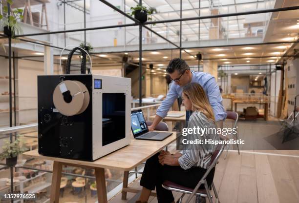 team of designers 3d printing a project at the office - printing out stock pictures, royalty-free photos & images
