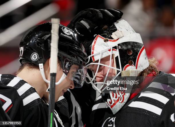 Yegor Sharangovich of the New Jersey Devils congratulates Mackenzie Blackwood after Blackwood recorded a shut out against the Philadelphia Flyers at...