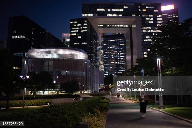 Pedestrian walks past the government offices and the Legislative Council building at night on November 26, 2021 in Hong Kong, China. Hong Kong is set...