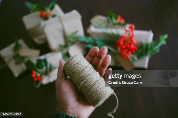 woman holds roll of jute twine - roll of wrapping paper stock pictures, royalty-free photos & images