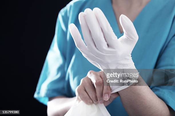 doctor wearing a surgical glove? - surgical glove stock pictures, royalty-free photos & images