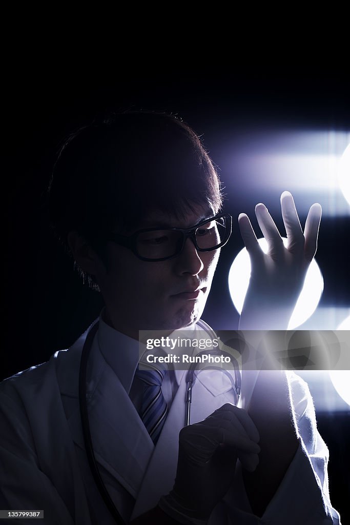 Doctor wearing a surgical gloves