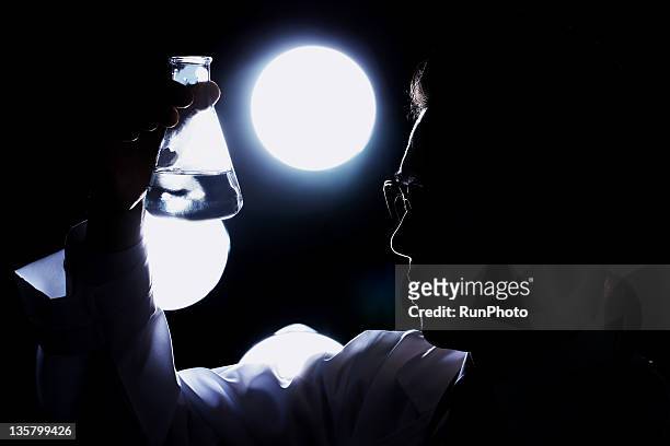 doctor doing drug research - back lit doctor stock pictures, royalty-free photos & images