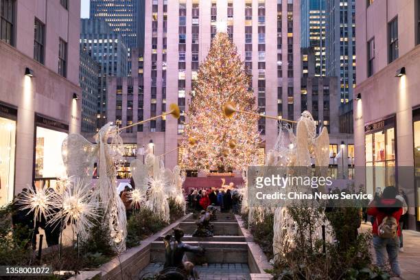 People visit the Rockefeller Center Christmas tree on December 8, 2021 in New York.