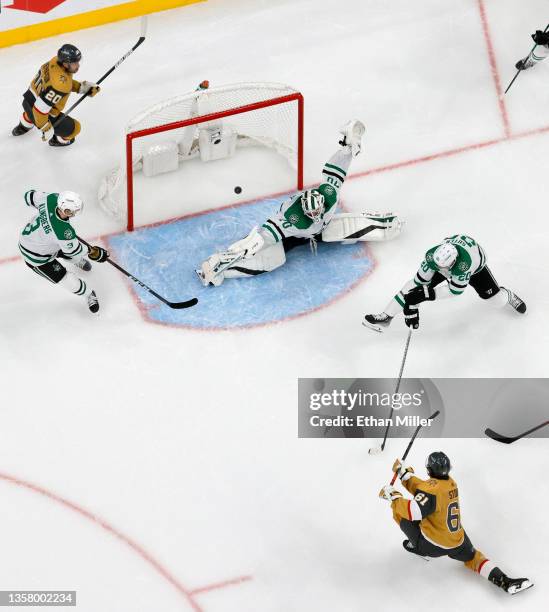 Mark Stone of the Vegas Golden Knights scores a third-period goal against Braden Holtby, Ryan Suter and John Klingberg of the Dallas Stars during...