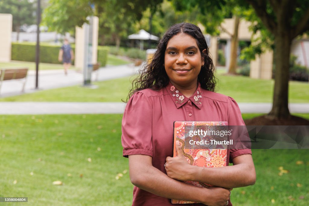 Female Aboriginal Australian Student Holding Laptop