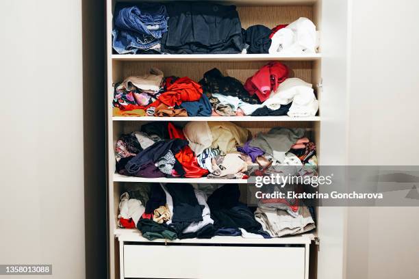 a wardrobe with bright clothes. - cabinet imagens e fotografias de stock
