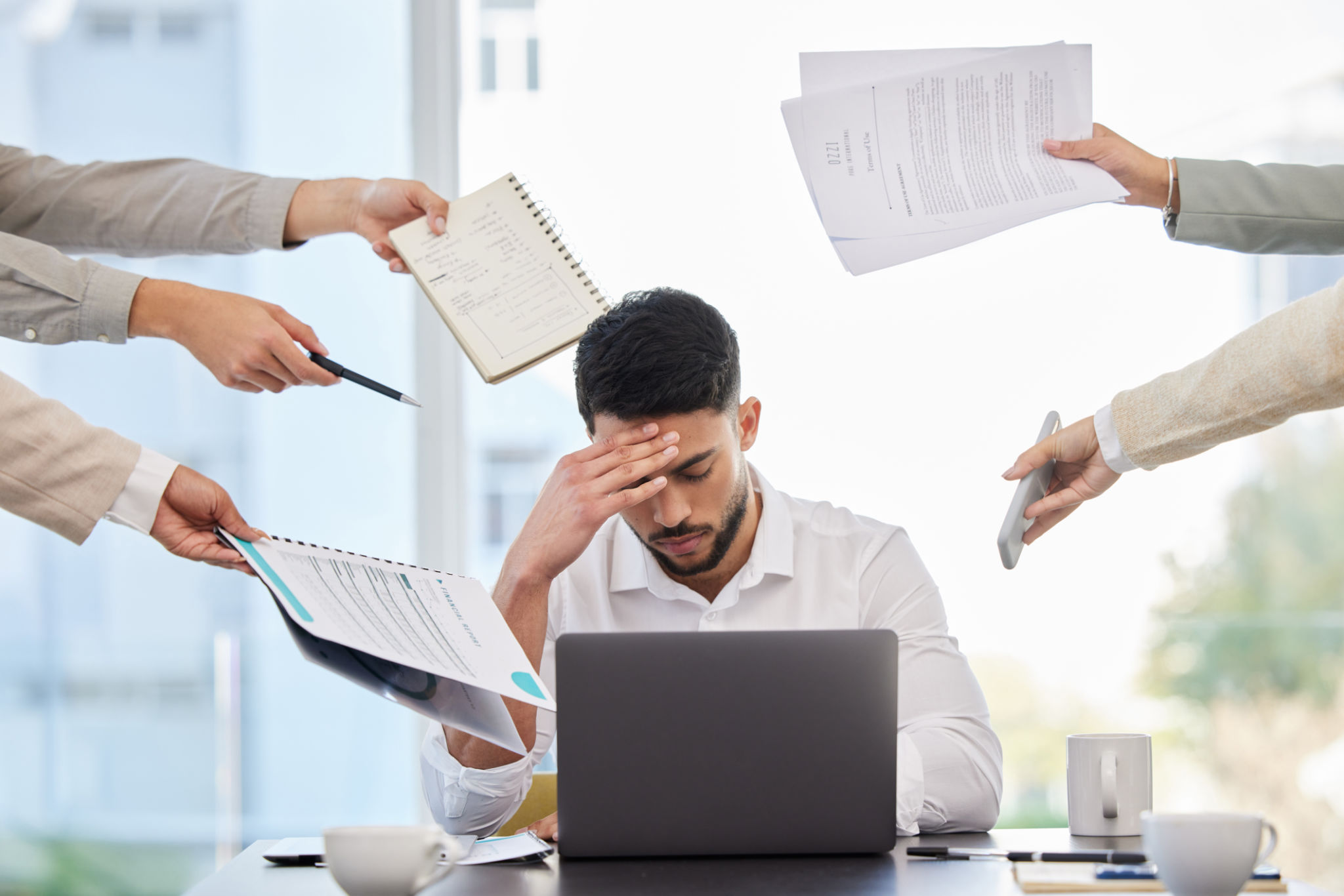 Shot of a young businessman looking stressed at work Shot of a young businessman looking stressed at work