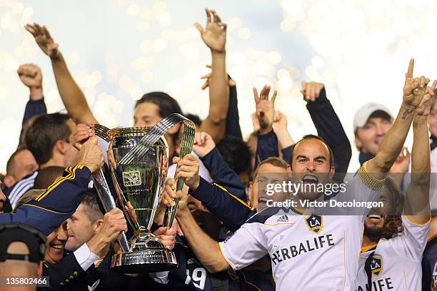 Landon Donovan of the Los Angeles Galaxy and his teammates celebrate with the Philip F. Anschutz Trophy on the podium after defeating the Houston...