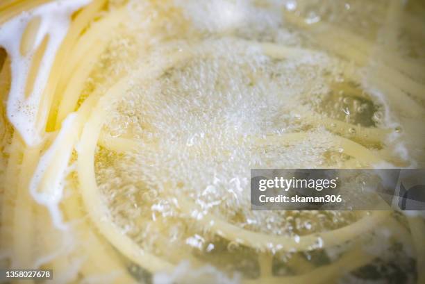 boil water with spaghetti  before cooking italian pasta - boiling pasta stock pictures, royalty-free photos & images