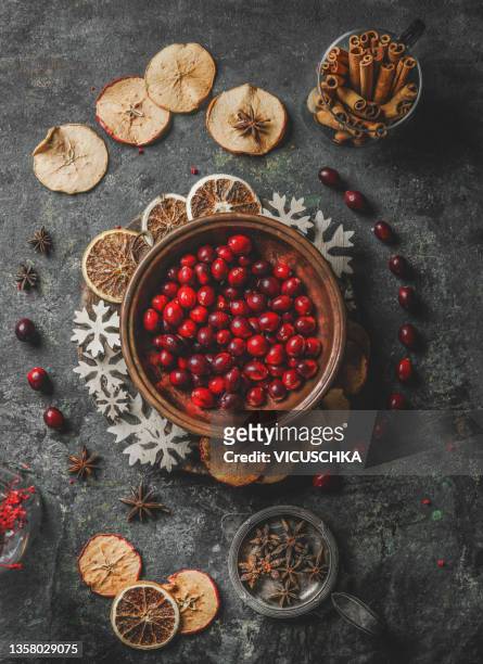 mulled wine ingredients on rustic concrete table - cranberries stock pictures, royalty-free photos & images