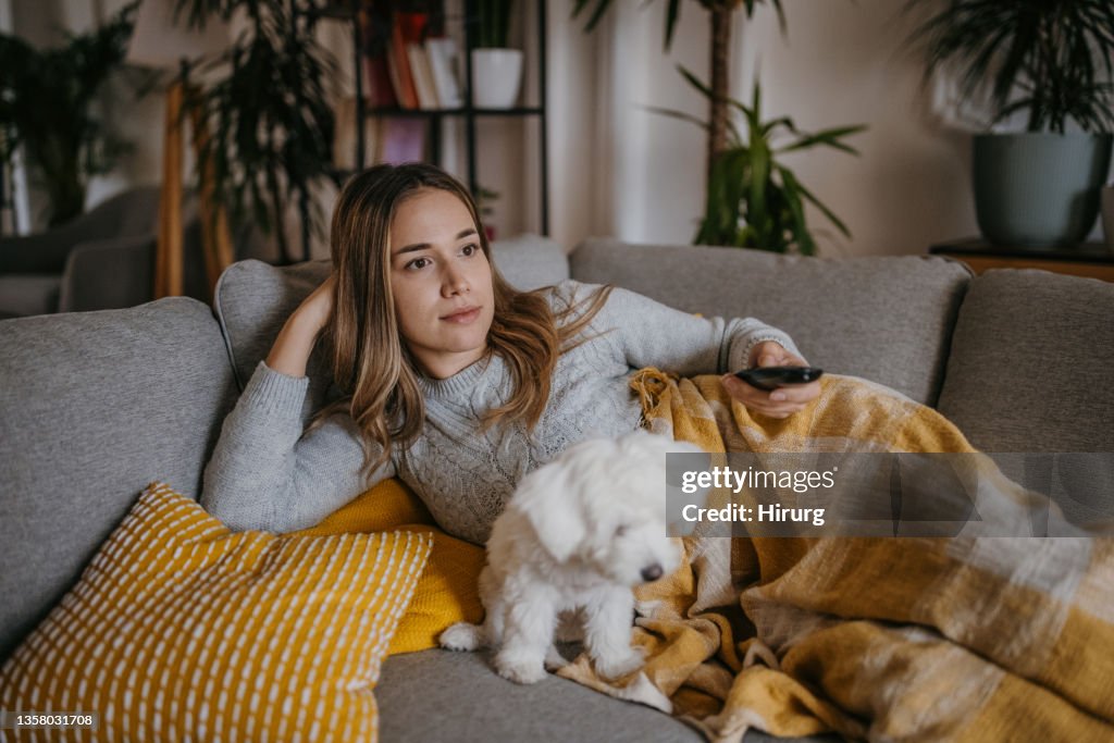 Woman watching TV at home