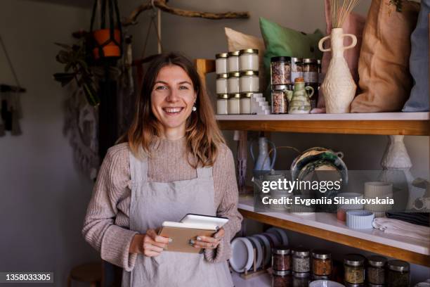 portrait of woman, small business owner, in her shop. - entrepreneurship stock-fotos und bilder